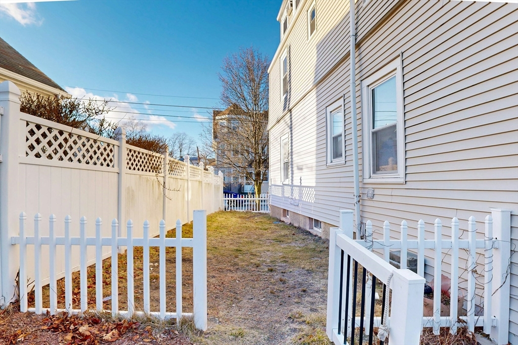 58 Dearborn Street Medford, MA 02155 - Photo 33 of 38 a view of a brick house with a small yard