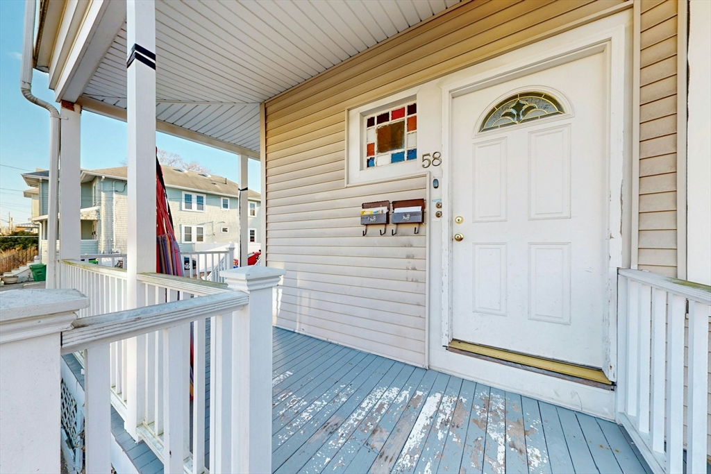 58 Dearborn Street Medford, MA 02155 - Photo 5 of 38 a view of a hallway with wooden floor and staircase