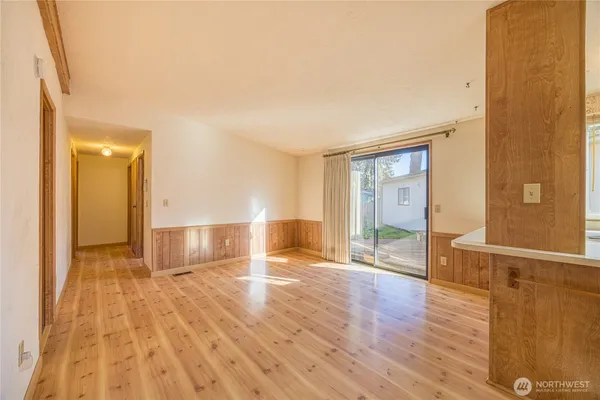 a view of empty room with wooden floor