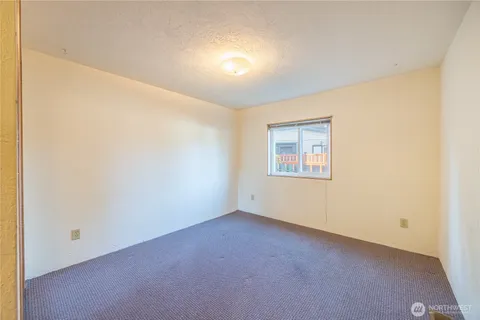 an empty room with a empty space and windows