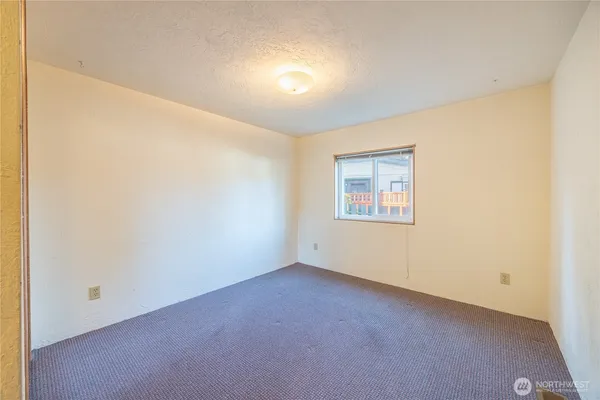 an empty room with a empty space and windows