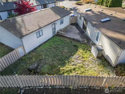 a view of a house with wooden fence