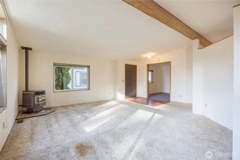 a view of a livingroom with an empty space and a window