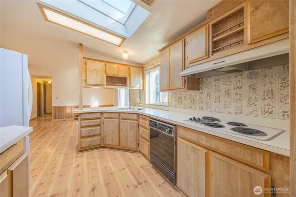 a kitchen with stainless steel appliances granite countertop a stove and a sink