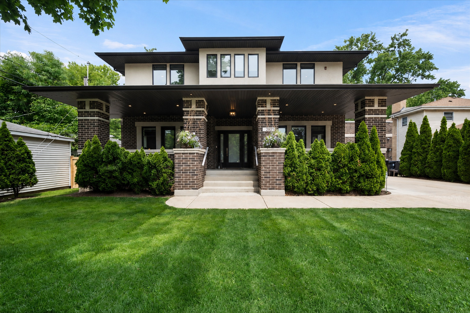 2921 Simpson Street Evanston, IL 60201 - Photo 1 of 41 a front view of a house with a yard and potted plants