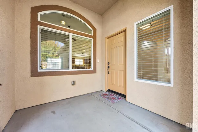 a view of a kitchen with a sink and a refrigerator a ceiling fan