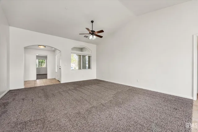 a large kitchen with stainless steel appliances kitchen island granite countertop a refrigerator a stove top oven and a sink with granite countertops