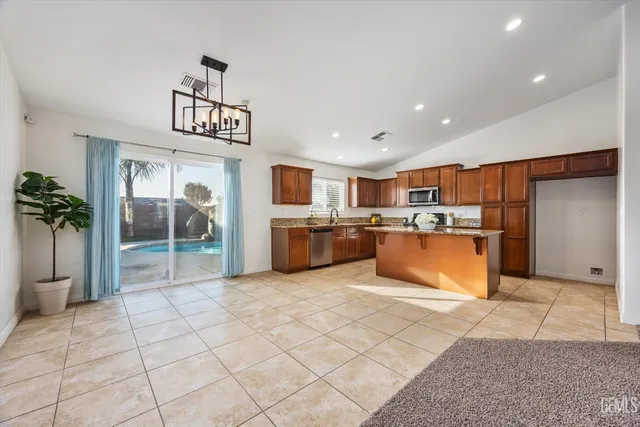 a kitchen with stainless steel appliances granite countertop a sink stove and cabinets