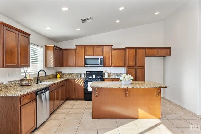 a view of a kitchen with a sink and dishwasher a refrigerator with wooden floor