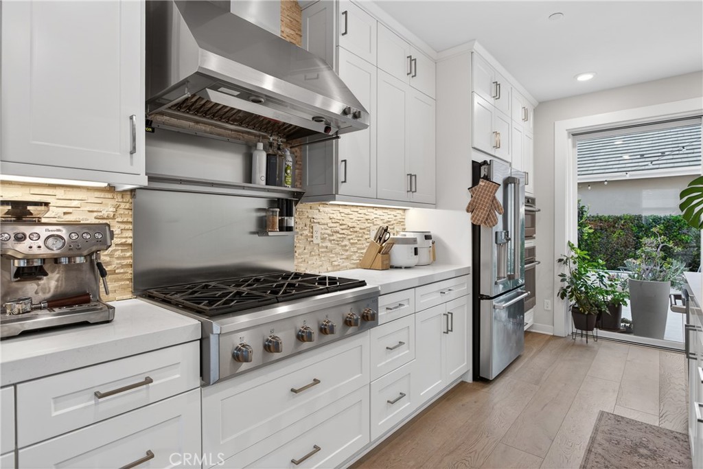 382 Chorus Irvine, CA 92618 - Photo 11 of 38 a kitchen with stainless steel appliances granite countertop a stove and a refrigerator