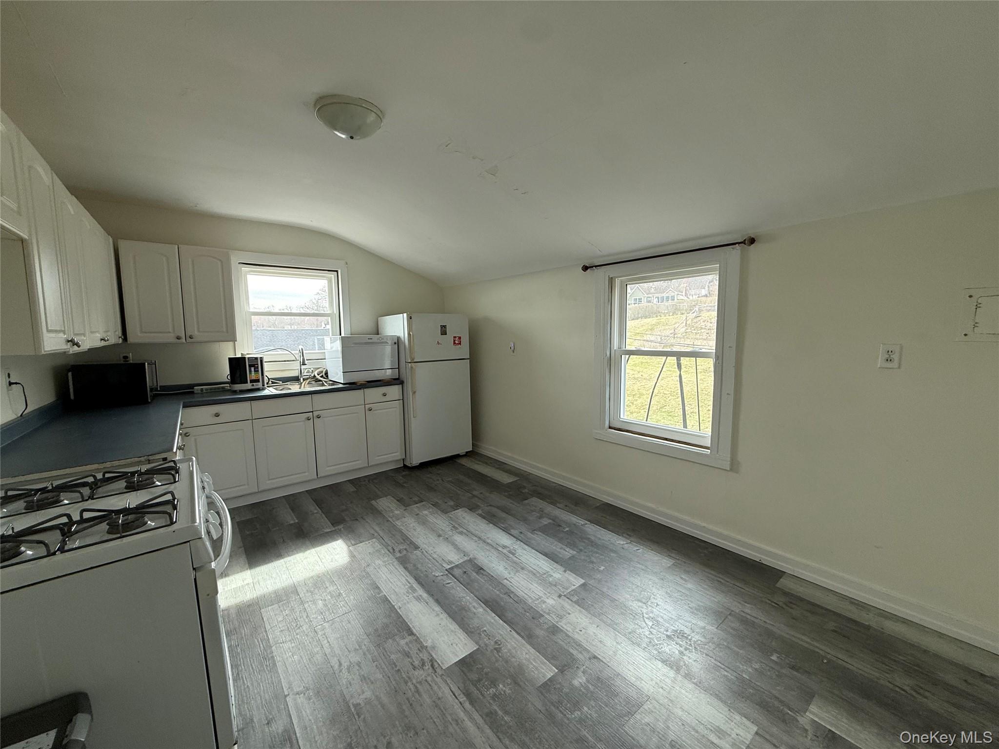 307 West Shore Road, Unit 5 Huntington, NY 11743 - Photo 6 of 12 Eat-in kitchen with white cabinets