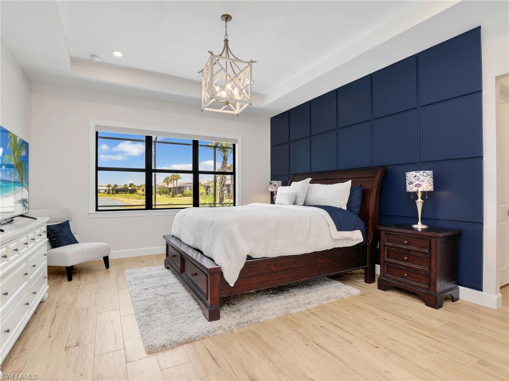 18412 Ridgeline Drive Estero, FL 33928 - Photo 28 of 50 a bedroom with a large bed and a tv on dresser