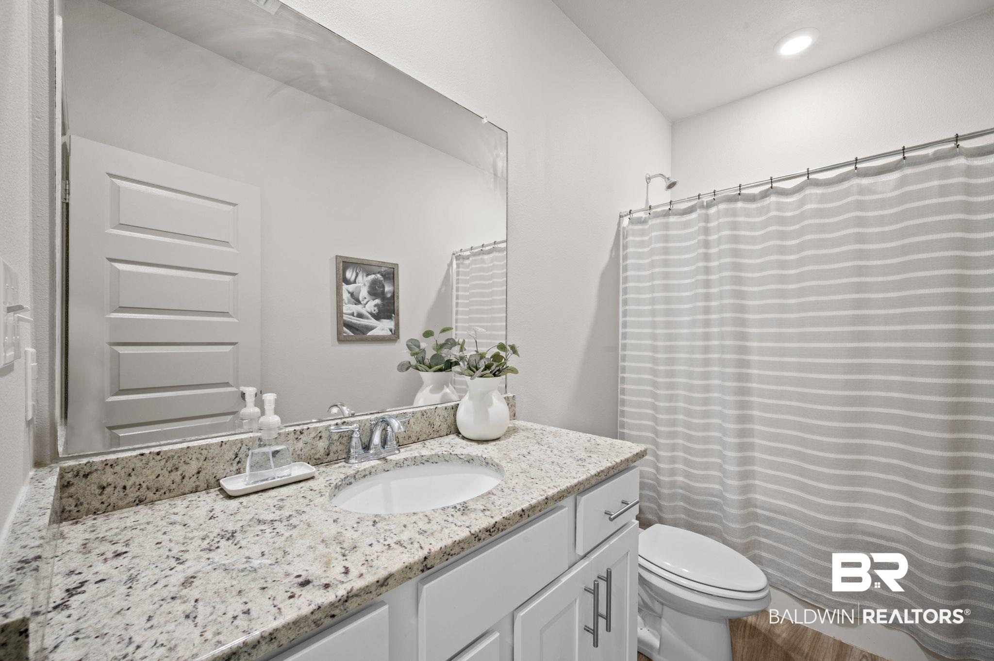 10169 Dunleith Loop Daphne, AL 36526 - Photo 39 of 40 Full bath with vanity, recessed lighting, and curtained shower
