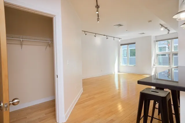 a view of a room with furniture and wooden floor