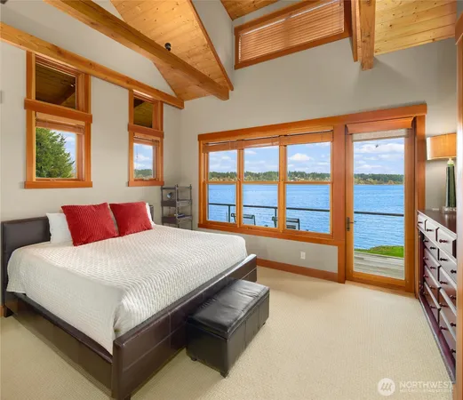 a large bed sitting in a bedroom next to a window