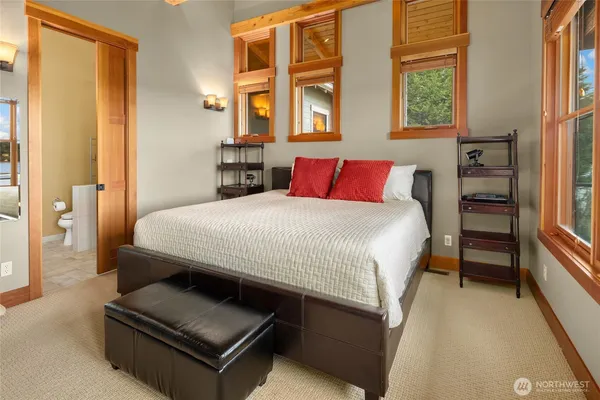 a bedroom with a bed couch and a window