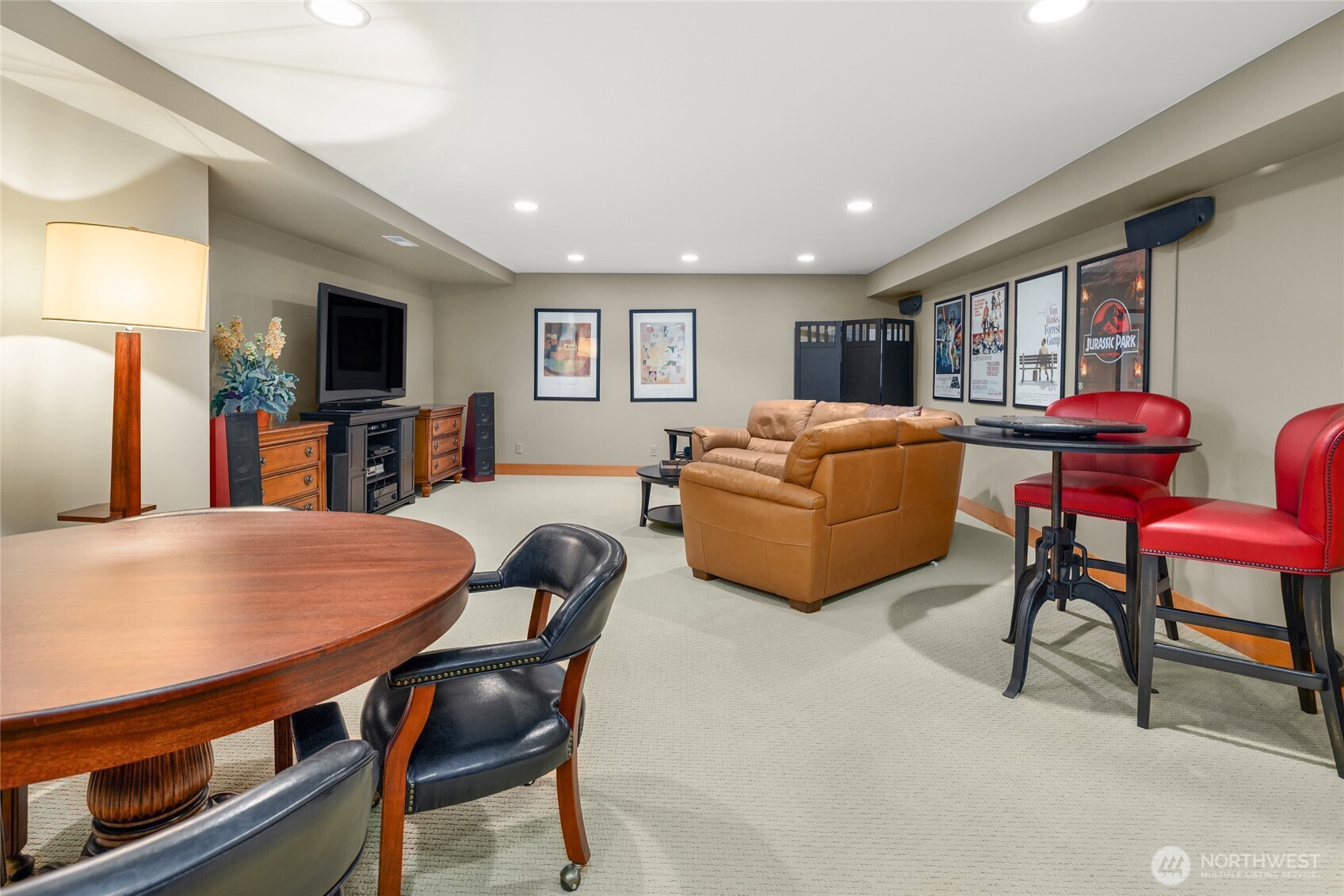15550 Sandy Hook Road Northeast Poulsbo, WA 98370 - Photo 23 of 40 a living room with furniture a flat screen tv and a dining table