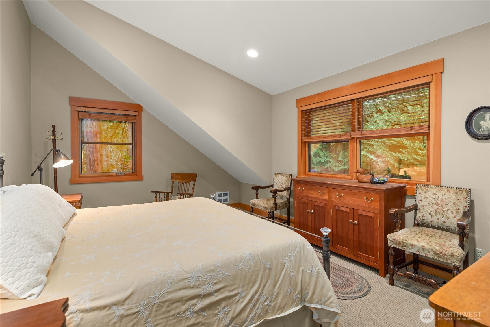 15550 Sandy Hook Road Northeast Poulsbo, WA 98370 - Photo 31 of 40 a bedroom with a bed and a couch next to a window