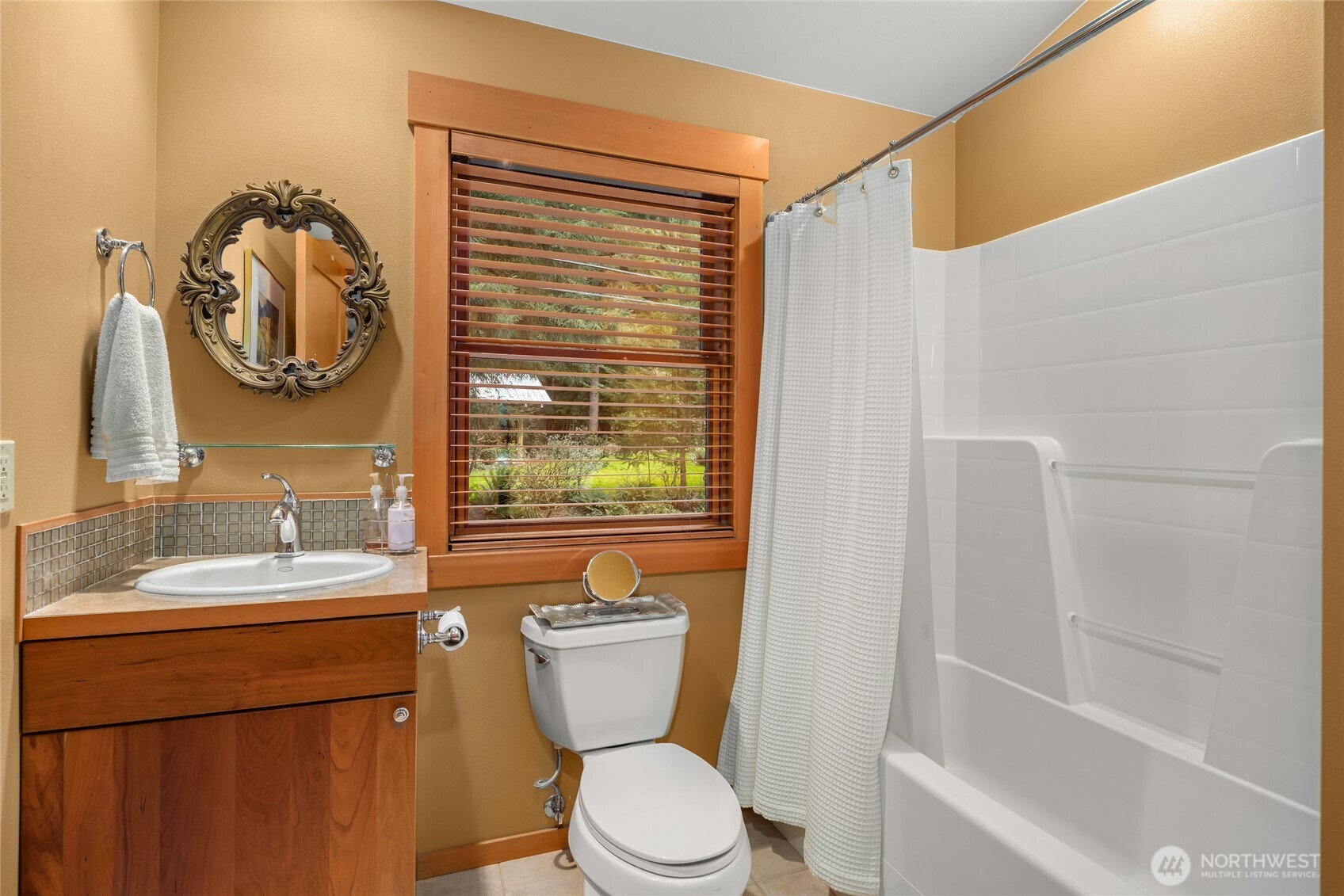 15550 Sandy Hook Road Northeast Poulsbo, WA 98370 - Photo 32 of 40 a bathroom with a toilet a sink and a bathtub