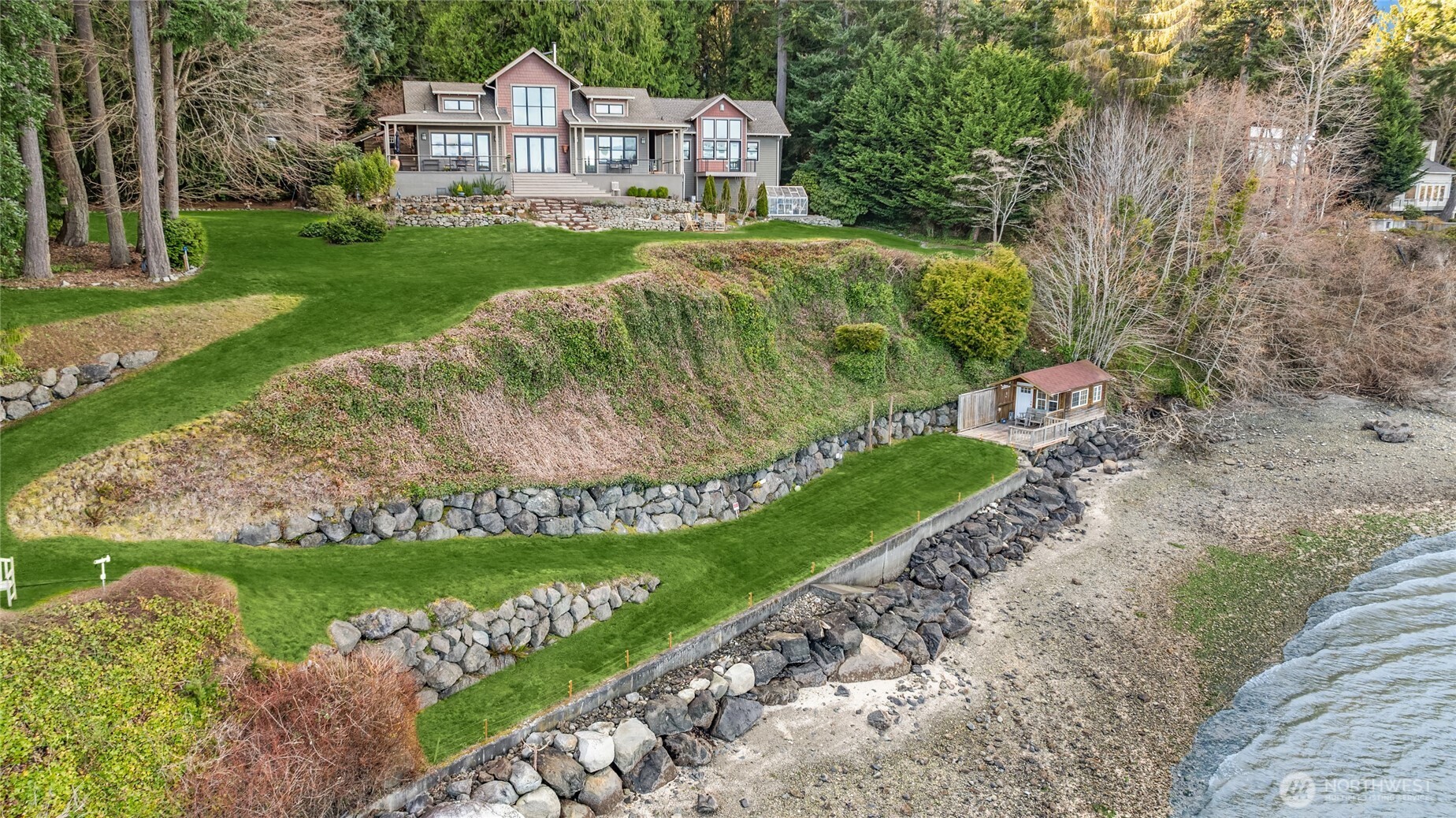 15550 Sandy Hook Road Northeast Poulsbo, WA 98370 - Photo 38 of 40 a front view of a house with a yard and green space