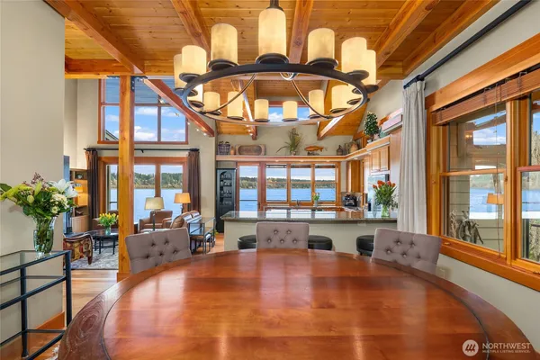 a large white kitchen with a large window and furniture