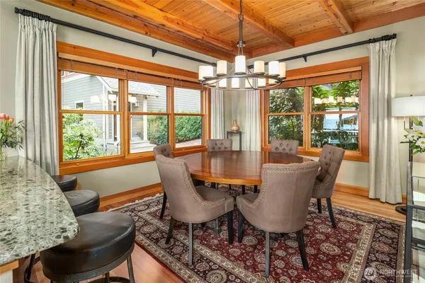 a dining room with furniture a chandelier and glass door