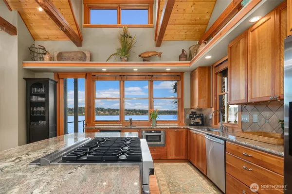 a kitchen with stainless steel appliances a stove and a sink