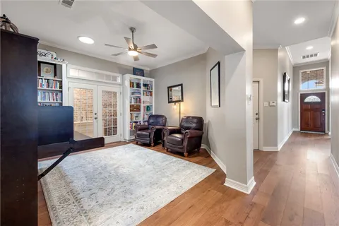a living room with furniture and a wooden floor
