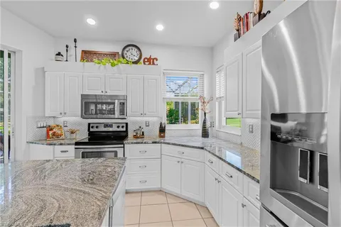 a kitchen with stainless steel appliances a stove a sink and a refrigerator