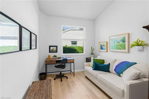 a living room with furniture and a potted plant