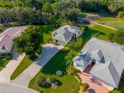 an aerial view of a house with garden space and lake view