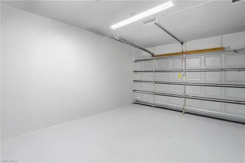 a view of a patio with table and chairs under an umbrella