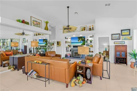 a room with furniture a dining table and a chandelier