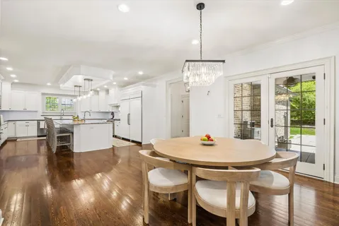 a open dining room with stainless steel appliances furniture a window and kitchen view