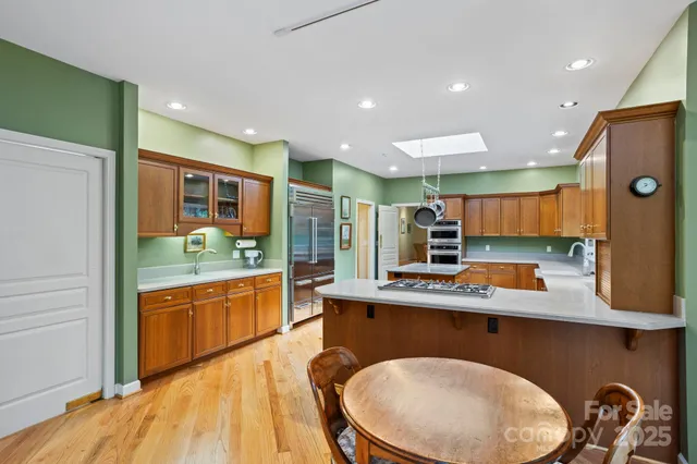 a kitchen with stainless steel appliances granite countertop a sink and cabinets