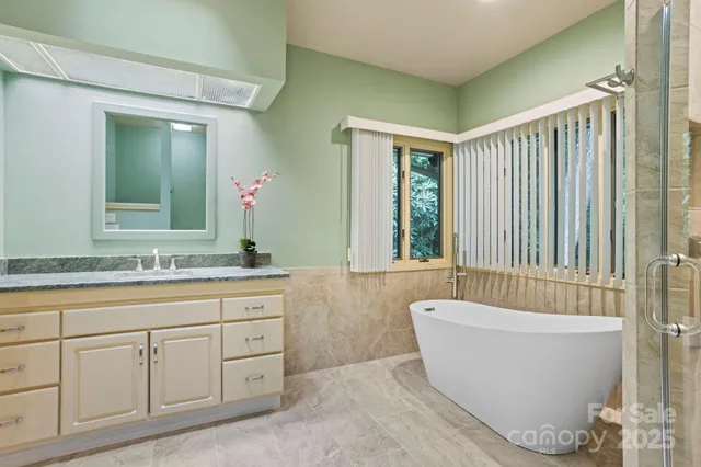 a spacious bathroom with a bathtub and a sink