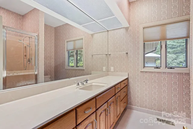 a bathroom with a double vanity sink and a mirror