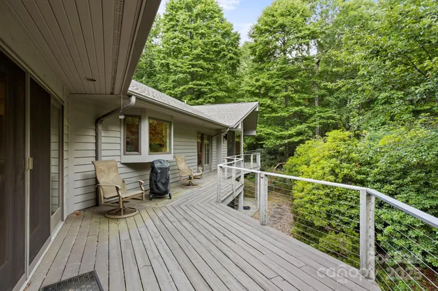 a view of a chair and tables on the wooden deck