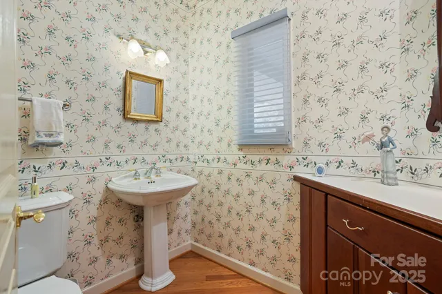 a bathroom with a sink a toilet and mirror