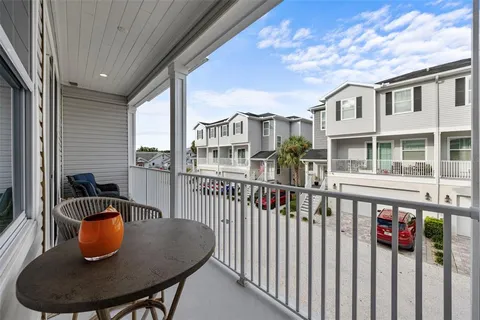 a view of a balcony with dining area and furniture