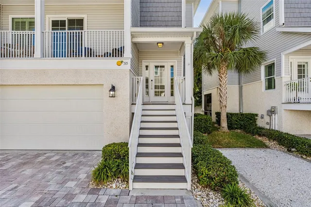 a kitchen with stainless steel appliances granite countertop a kitchen island hardwood floor and a sink