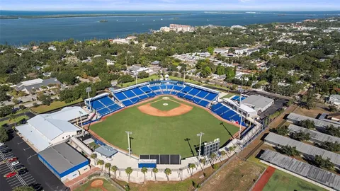 a sign of golf club on a under a tree