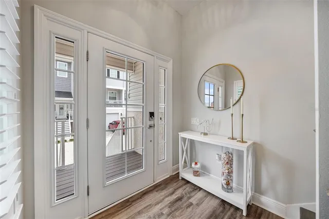 a kitchen with kitchen island granite countertop a sink cabinets and wooden floor