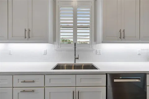 a kitchen with a sink and a window