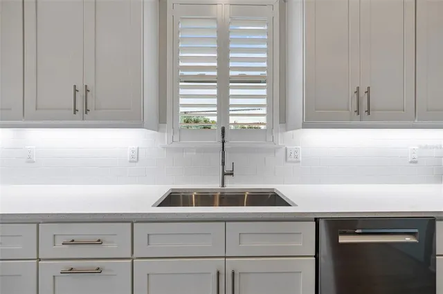 a bathroom with double vanity sinks and a mirror