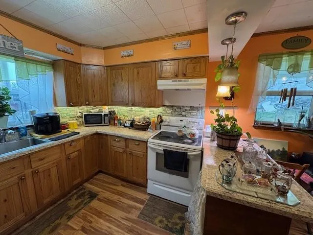 a kitchen with stainless steel appliances a stove a sink and a refrigerator
