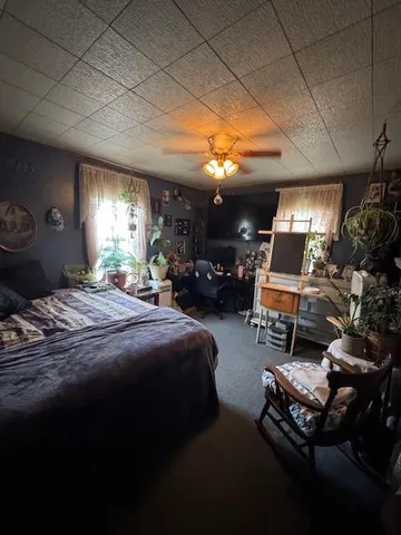 a bedroom with furniture and a chandelier