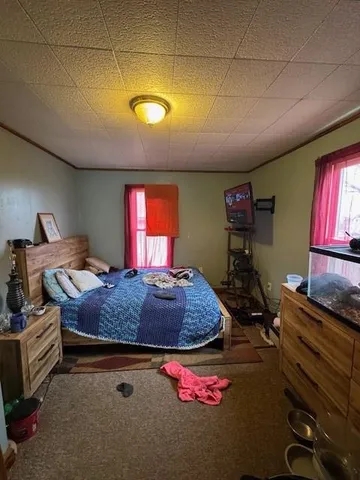 a bedroom with bed and a bookshelf