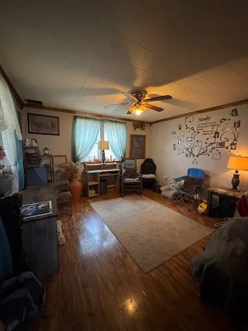 a living room with furniture a window and gym equipment