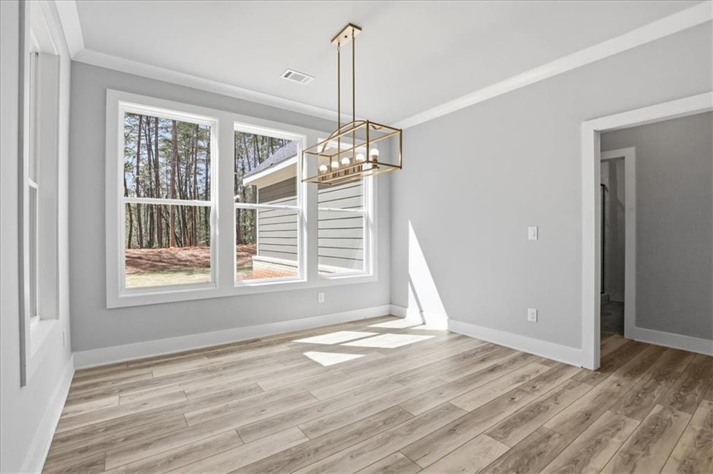 196 Red June Lane Clarkesville, GA 30523 - Photo 21 of 69 a view of an empty room with wooden floor and a window